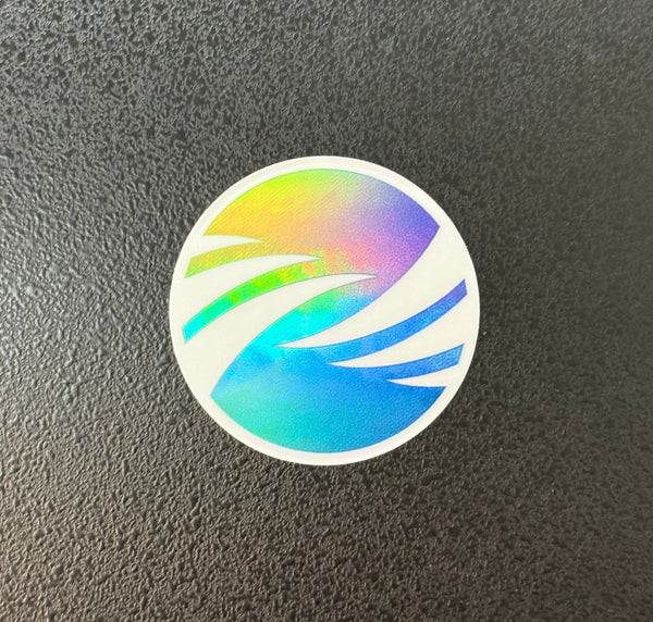 Holographic rainbow swirl sticker on a textured black surface