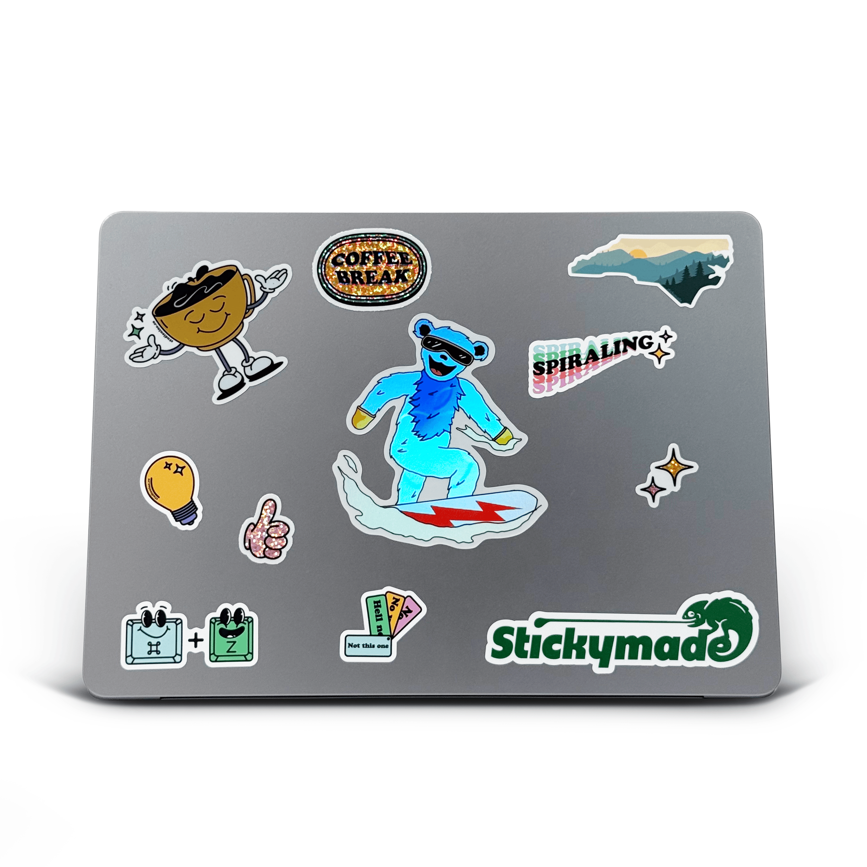 Laptop with various stickers on a white background